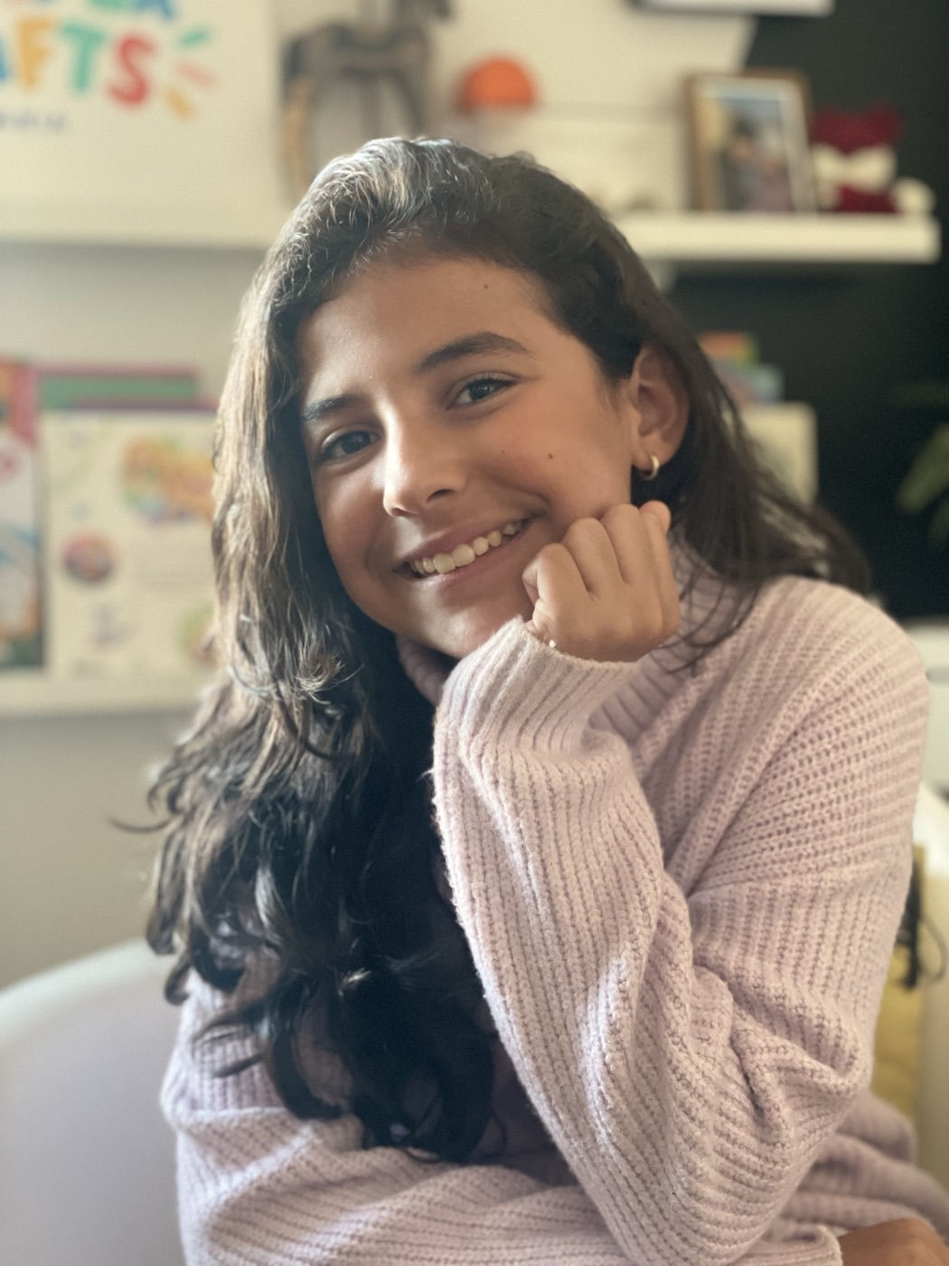 Maria smiling, resting her chin on her hand